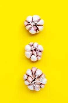 Cooking ingredients, Garlic on yellow background. Healthy eating concept