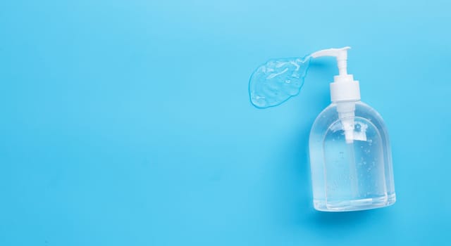 Alcohol hand sanitizer gel in pump bottles for hand hygiene corona virus (Covid-19) protection. Blue background with copy space