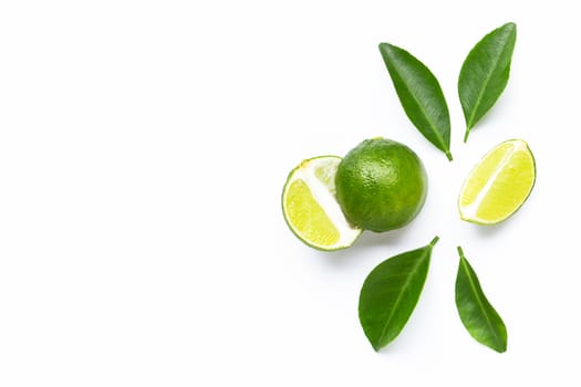 Fresh limes and leaves on white background.