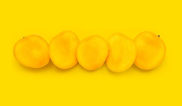 Tropical fruit, Mango slices on yellow background. Top view