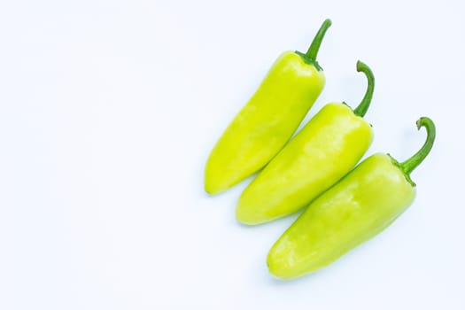 Green hot peppers on a white background.