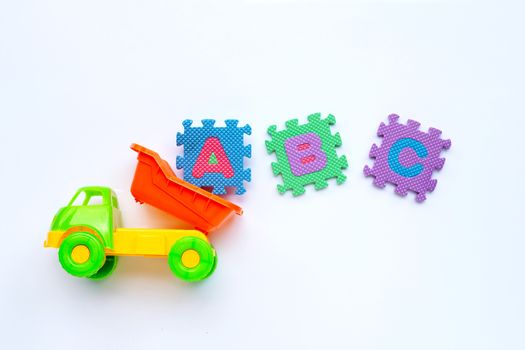 Colorful Kids toys with english alphabet puzzle on white background. Education concept, Copy space