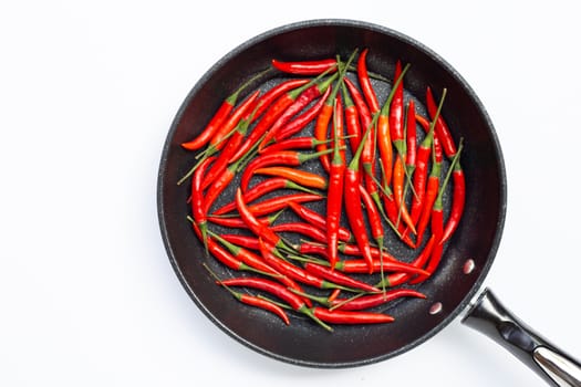 Hot chili peppers in a pan on white background. Top view
