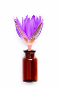 Essential oil bottle glass with  lotus flower on white background.