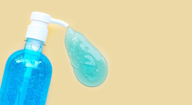 Alcohol hand sanitizer gel in pump bottles for hand hygiene corona virus (Covid-19) protection. yellow background with copy space.