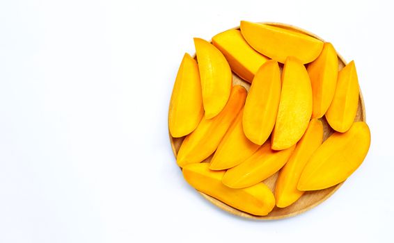 Tropical fruit, Mango  slices on wooden plate on white background. Copy space