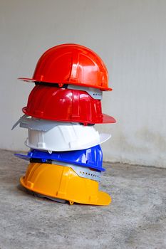 Construction helmets on concrete background. 