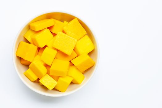 Tropical fruit, Mango cube slices in white bowl on white background. Copy space