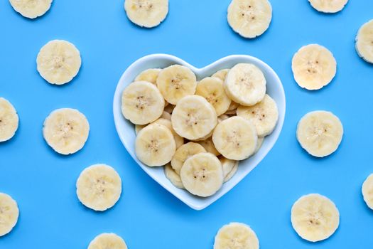 Banana slices on blue background. Top view