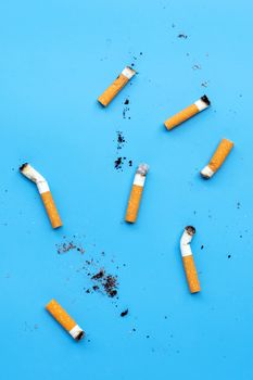 Cigarette butts on blue background. Top view