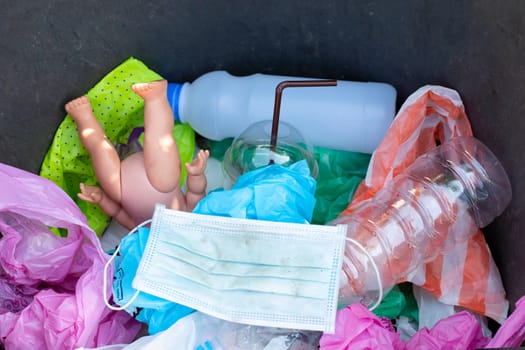 Dirty used surgical masks in a garbage bin.