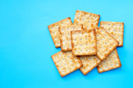 Crackers with sugar on blue background. Top view