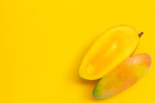 Tropical fruit, Mango  on yellow background. Juicy and sweet