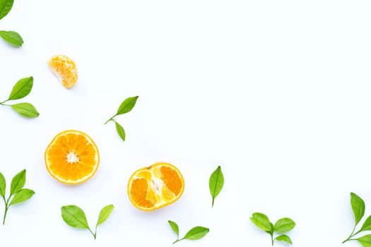 Fresh orange citrus fruit with leaves on white background. Juicy, sweet and high vitamin C. Top view