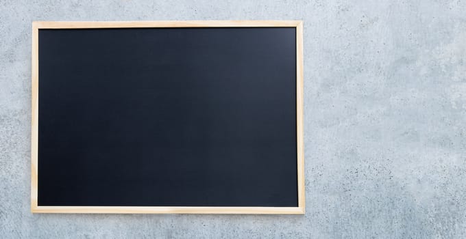 Black school chalkboard on concrete wall for background.  Copy space