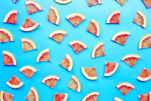 High vitamin C. Juicy grapefruit slices on blue background. Top view