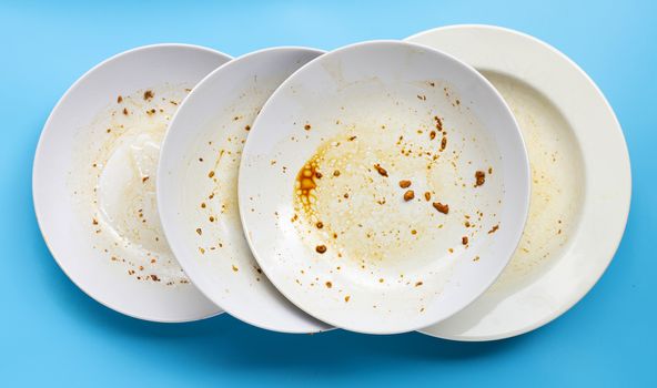 Dirty dishes on blue background. Top view
