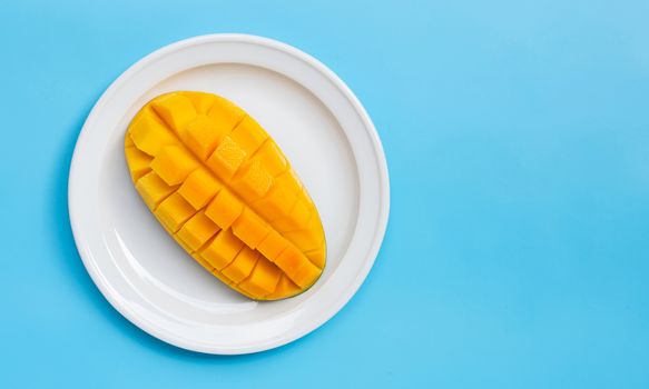Tropical fruit, Mango on blue background. Copy space