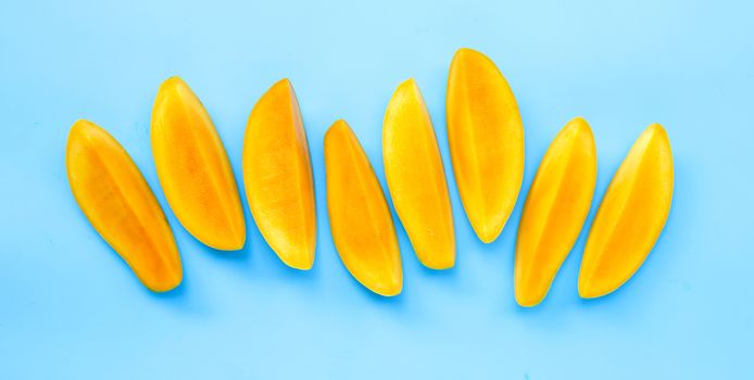 Tropical fruit, Mango slices on blue background. Top view