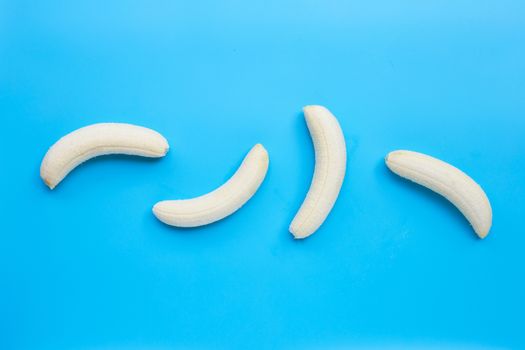 Banana on blue background. Top view with copy space