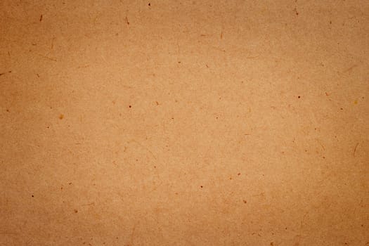 Sheet of brown paper or cardboard texture for background.
