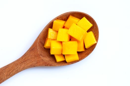 Tropical fruit, Mango cube slices on wooden spoon on white background. 