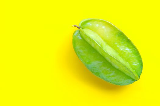 Star fruit on yellow background. Copy space