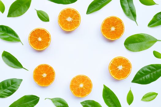 High vitamin C, Juicy and sweet. Frame made of orange fruit with leaves on white background. Copy space