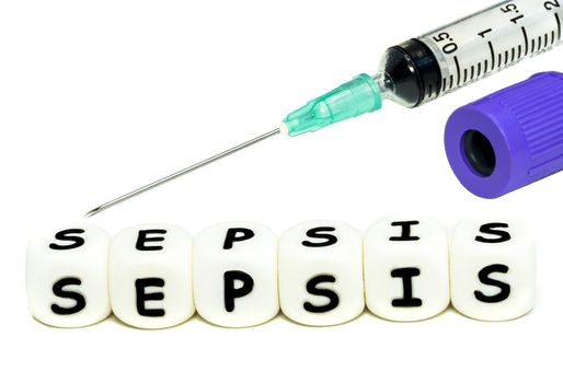 A laboratory test tube and a syringe for blood sampling in the patient with infection. The alphabet letters sepsis emphasize the awareness of this serious condition. Macro image on white background.