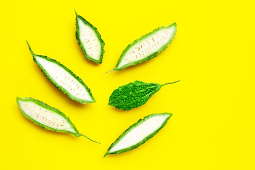 Bitter gourd on yellow background. top view