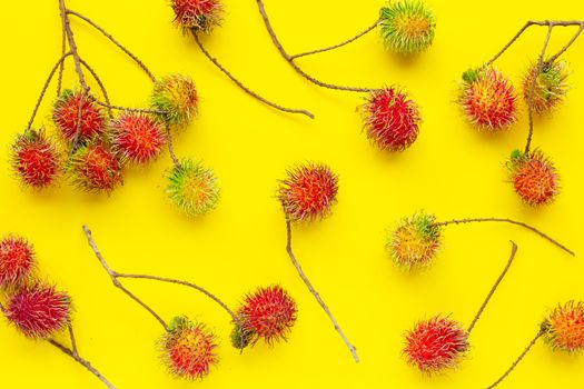 Top view of Rambutan on yellow background. 