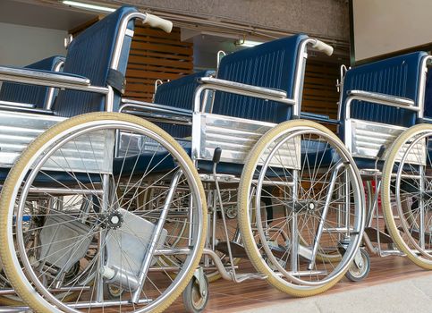 three wheelchairs parking on a raised platform, hospital, clinic, nursing home concept