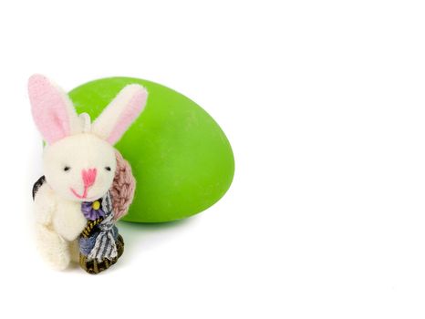 cute little handmade bunny and a green easter egg isolated on white background with copy space