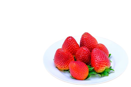 a bunch of large strawberries on a white plate, isolated on white background, copy space