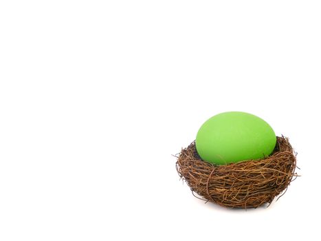 green easter egg in a bird nest, isolated on white backgound