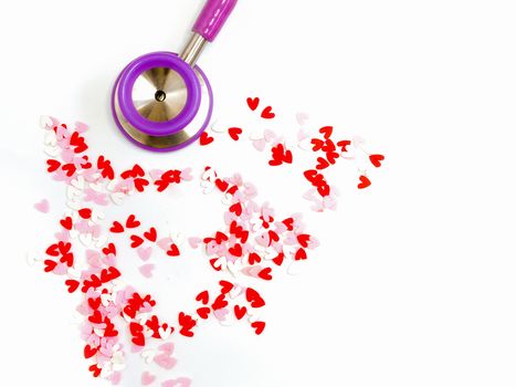 a stethoscope and red, white, and pink heart-shaped pieces of plastic confetti, abstract love and compassion, Valentines' Day, romance, concept, on white background