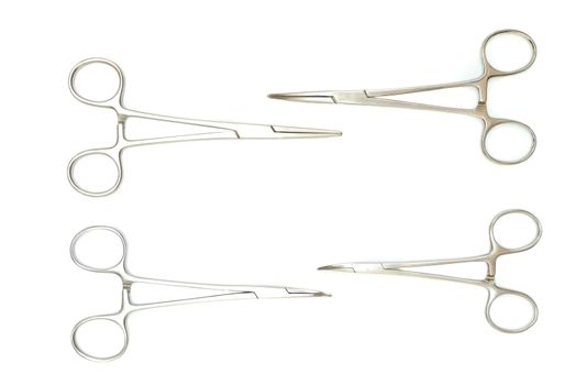 four surgical clamps, isolated on white background, top view