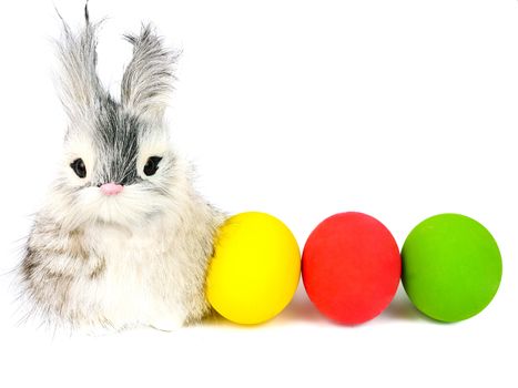 A cute little long hair bunny rabbit and bright colored easter egg, isolated on white background.