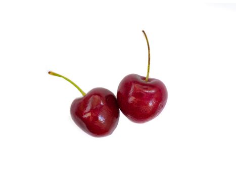 two shiny red cherries isolated on white background
