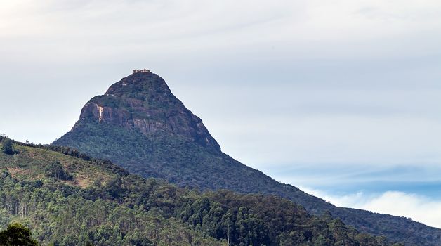 Sunrise over Adam's peak, Sri Lanka, mountain in the fog view from the jungle. Mountain landscape.