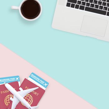 flat lay of passport , white plane model and computer laptop on pastel blue and pink color background with copy space. travel , visa and vacation concept