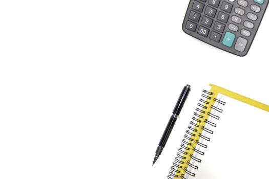 Top view of notebook a pen and a calculator, minimal office, isolated on white background