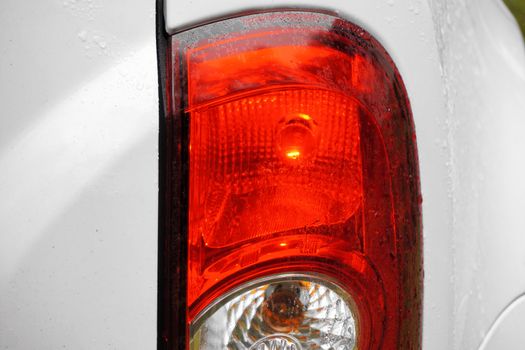 Red taillight of a car, close-up, detail