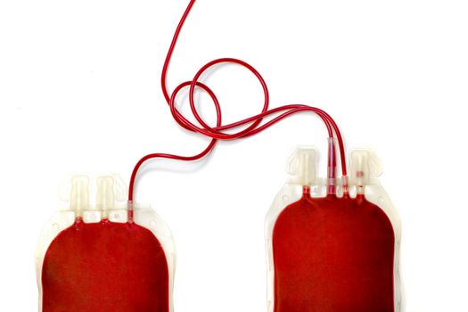 two plastic bags filled with fresh red blood isolated on white background. Blood donation, letting, transfusion, concept