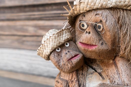 African tribal art. Wooden statuette of two monkeys with hat and glasses.