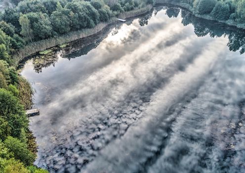 Aerial photograph with drone, morning reflection of the clouds in a pond