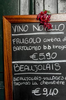 A menu of french and italian wines, on blackboard.