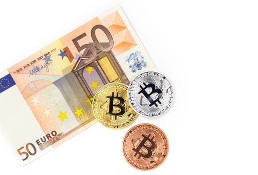 Financial concept with Bitcoins on fifty euro banknote. Traditional money vs cryptocurrency concept.