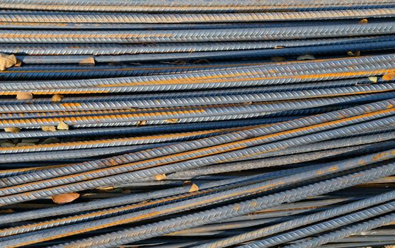 stack of old rusty iron rods for building construction