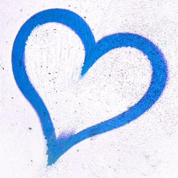 Concept or conceptual painted blue abstract heart shape love symbol, dirty wall background, metaphor to urban and romantic valentine, grungy style.